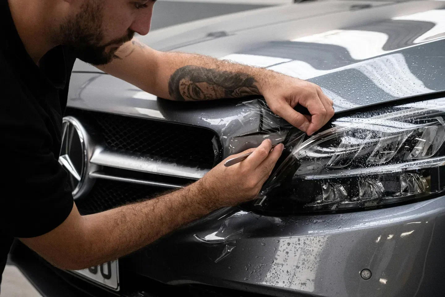 A car receiving professional Paint Protection Film (PPF) in Palm Beach Gardens, FL, safeguarding the paint from scratches, chips, and UV damage.